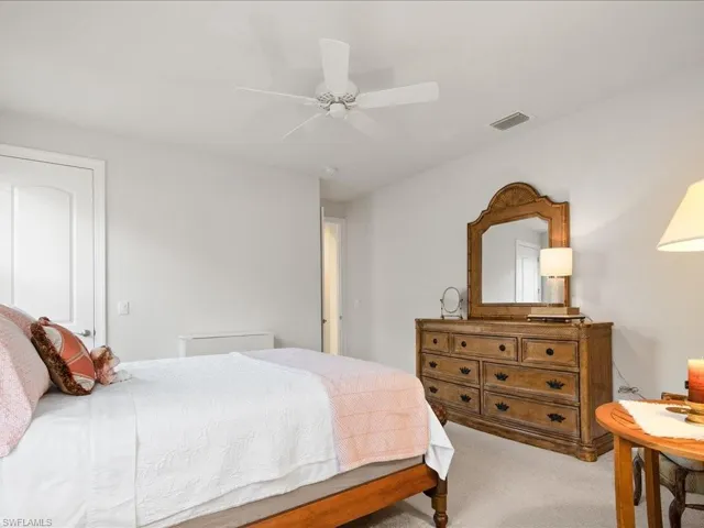 Bedroom featuring ceiling fan and light colored carpet