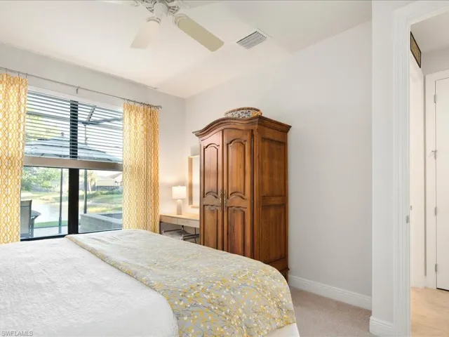 Carpeted bedroom featuring access to outside and ceiling fan