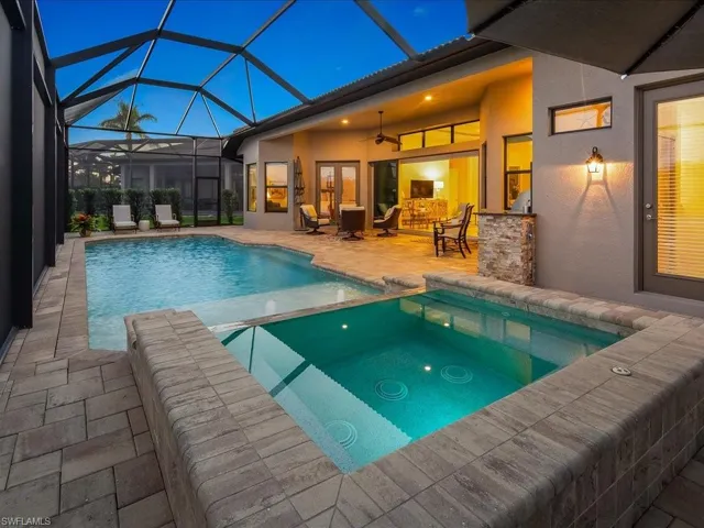 View of pool with a lanai, outdoor lounge area, ceiling fan, and a patio