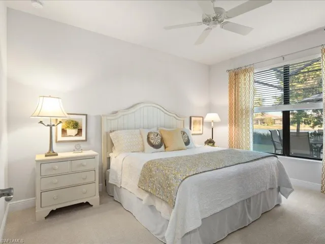 Bedroom with ceiling fan and light colored carpet