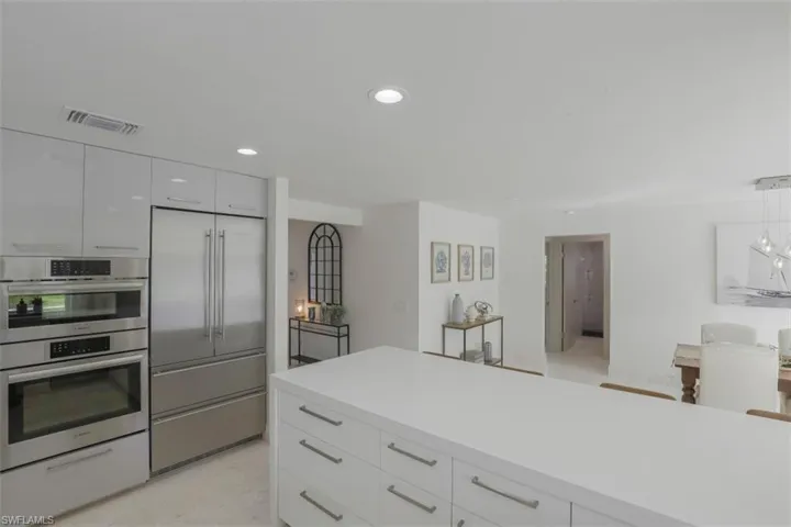 Kitchen featuring white cabinets, stainless steel appliances, recessed lighting, modern cabinets, and pendant lighting