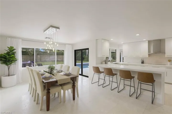 Dining area with recessed lighting and a chandelier