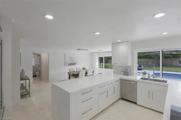 Kitchen featuring hanging light fixtures, dishwasher, white cabinetry, recessed lighting, and modern cabinets
