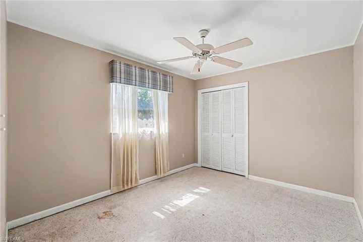 Neutral-toned walls complement the light-colored carpeting