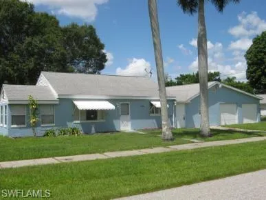 Single story home with a garage and a front yard