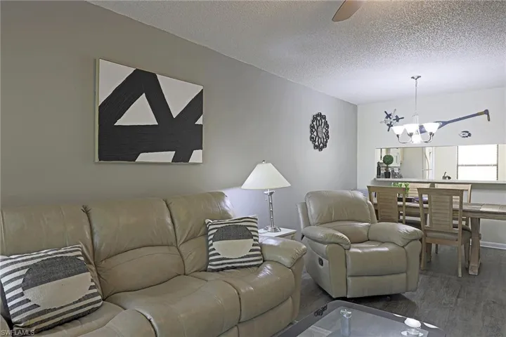Living area featuring wood-finish flooring and a textured ceiling