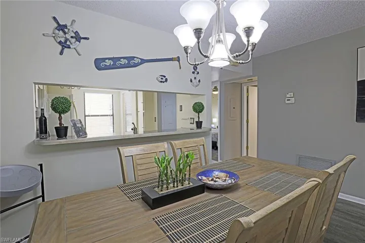 Dining area featuring a contemporary chandelier and light wood-finish flooring