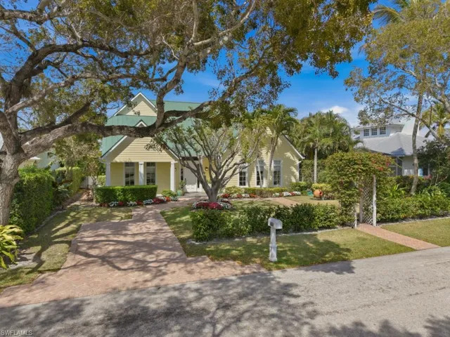 Obstructed view of property featuring a porch and a front lawn