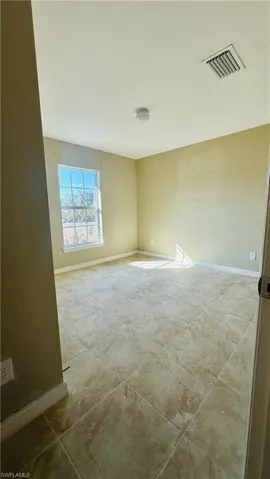 Empty room featuring baseboards