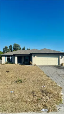 Single story home with stucco siding, driveway, and a garage