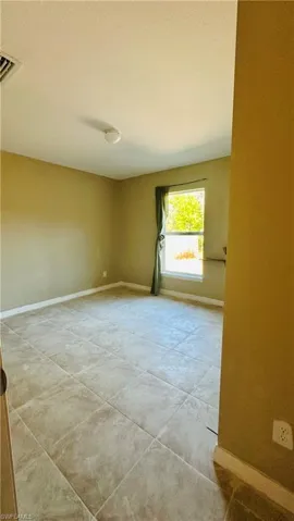 Unfurnished room featuring baseboards