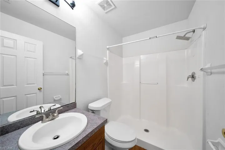 Bathroom with a stall shower and vanity