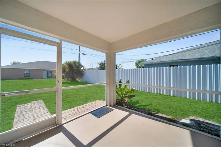 Unfurnished sunroom with a patio area