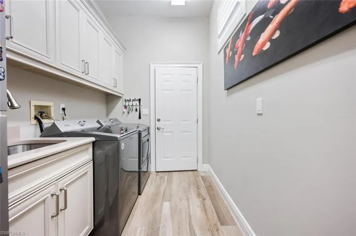 Laundry Room with custom cabinets and access to 2 car garage air conditioned garage