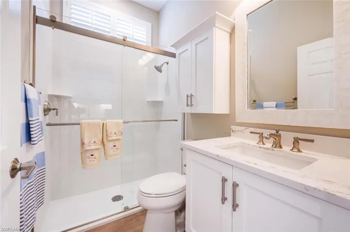 Casita Bathroom with Plantation shutters,  quartz countertop, custom cabinets and custom Mirror.