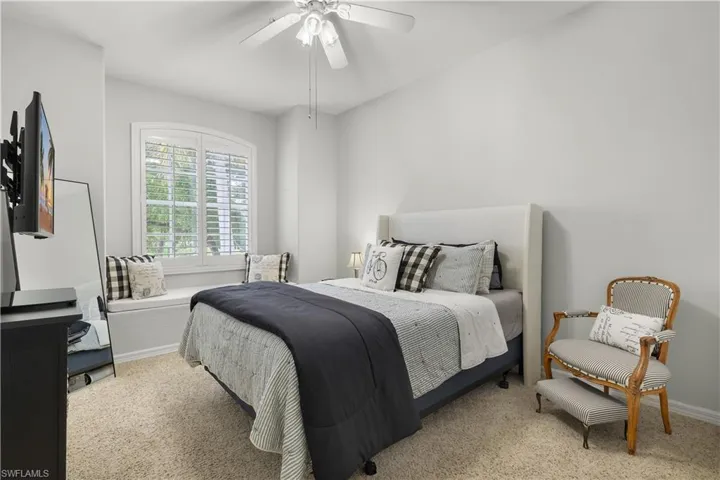 Bedroom featuring light colored carpet and ceiling fan