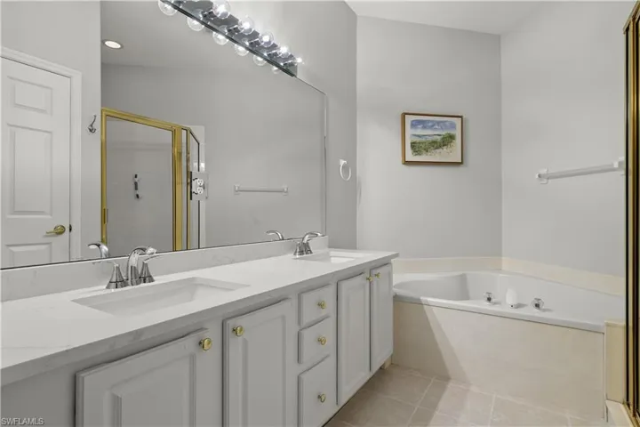 Bathroom with vanity, independent shower and bath, and tile patterned floors