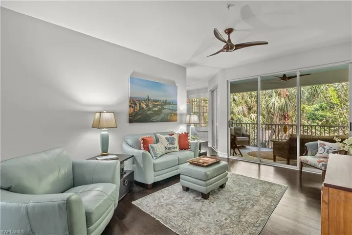 Living room featuring ceiling fan and dark hardwood / wood-style flooring