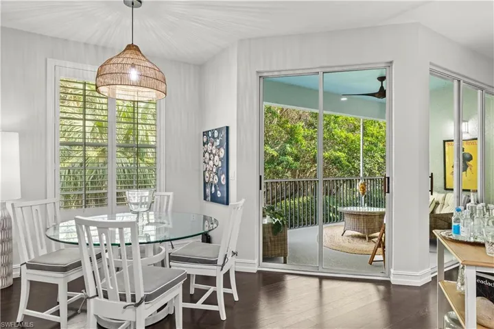 Dining space with dark wood-type flooring and plenty of natural light