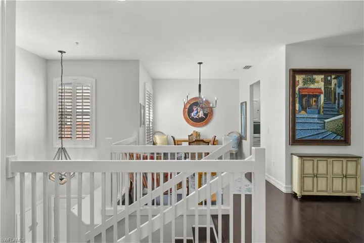 Staircase featuring a chandelier and wood-type flooring