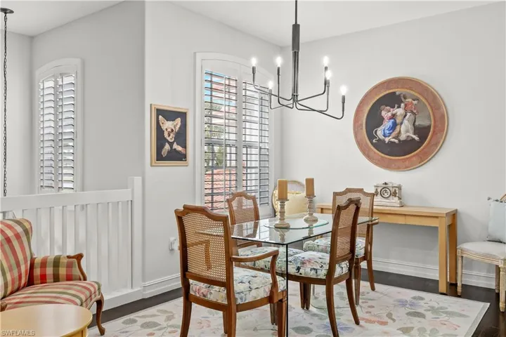 Dining area featuring an inviting chandelier and wood-type flooring