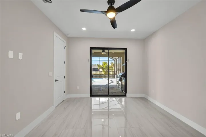 Empty room with ceiling fan, a sunroom, and recessed lighting