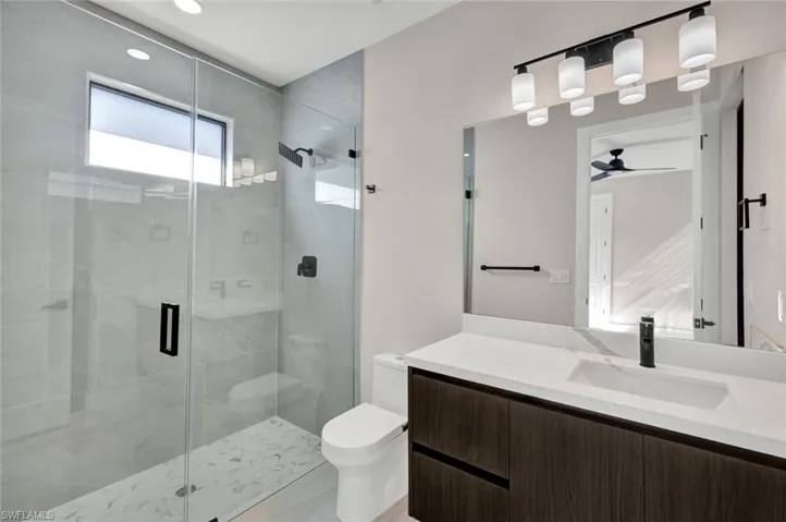 Bathroom featuring vanity and a stall shower
