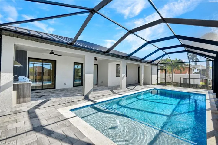 View of swimming pool with a sunroom, a lanai, and a patio area