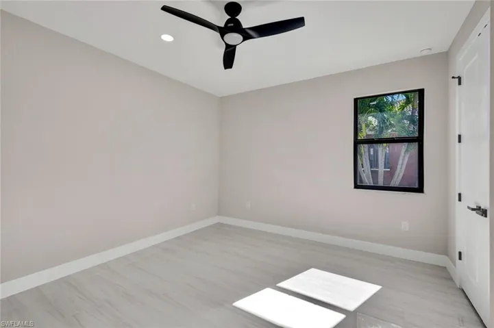Spare room with ceiling fan, light wood-style floors, and recessed lighting