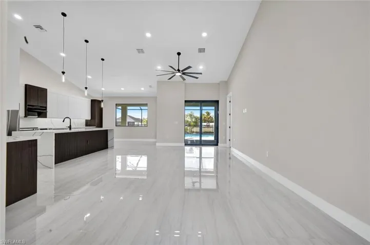 Unfurnished living room featuring high vaulted ceiling, ceiling fan, and recessed lighting