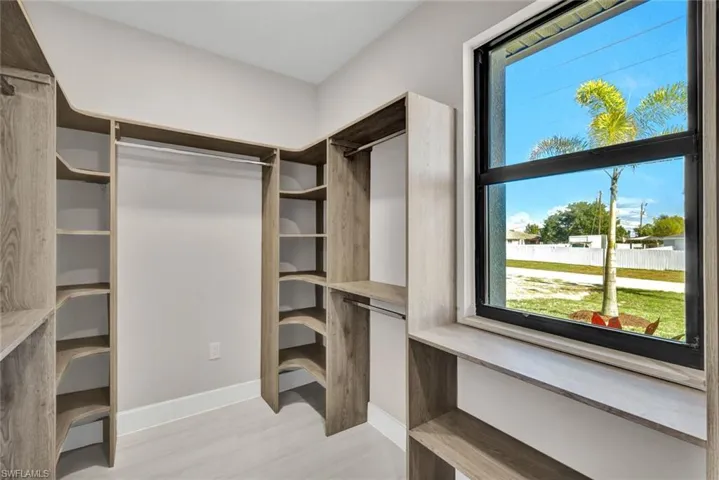 Walk in closet featuring light wood-style flooring