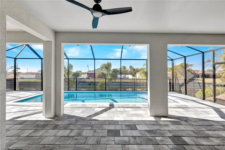 View of swimming pool with a patio, a sunroom, and a lanai