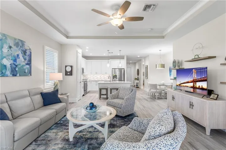 This home is built for entertaining! Tray ceiling in living area.