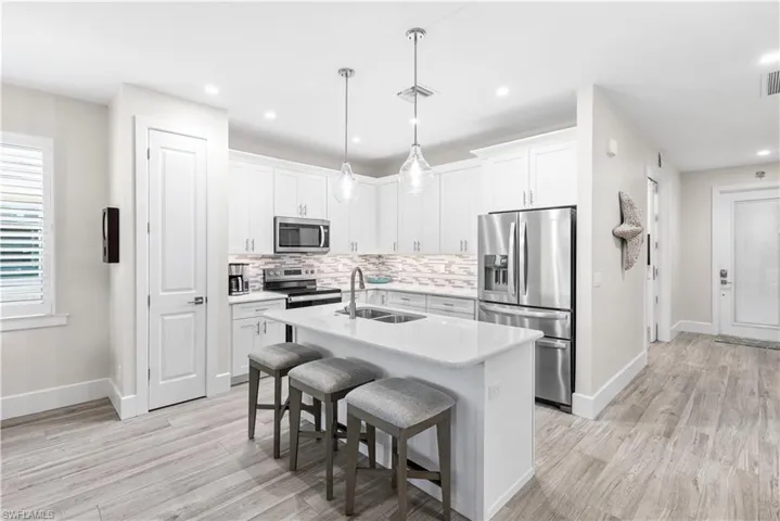 42" cabinets, quartz countertops, glass backsplash, custom lighting.