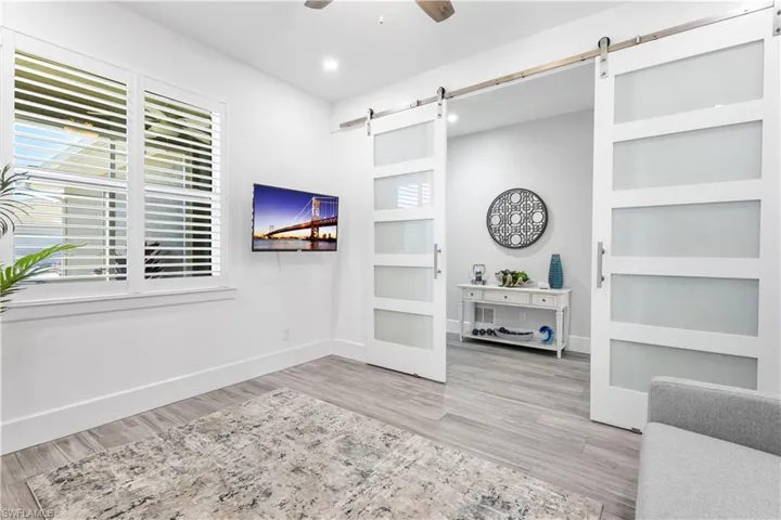 Den/office/t.v. room the possibilities are endless with the privacy of these frosted glass barn doors. Plantation shutters.