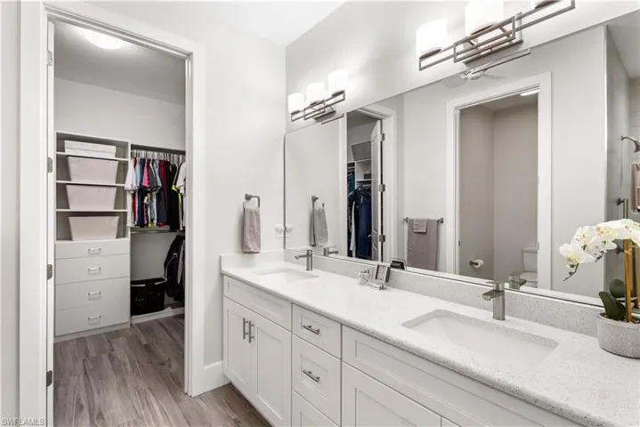 This delicious spa like bathroom has dual comfort height vanities, sparkling white quartz countertops, private water closet, walk in shower and a huge walk in custom design closet!