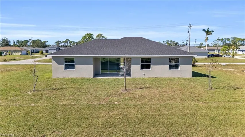 Rear view of house with a yard