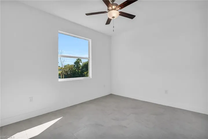 Spare room with ceiling fan