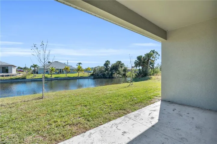 View of yard featuring a water view and a patio