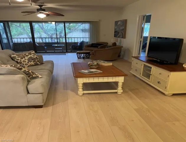 Living room featuring light hardwood / wood-style flooring and ceiling fan