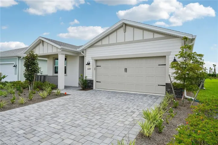 Ranch-style house with a garage and covered porch