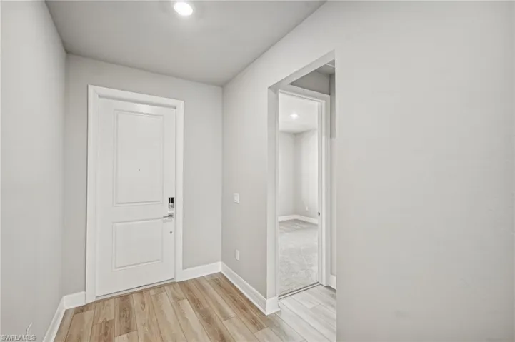 Corridor with light hardwood / wood-style floors