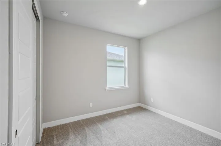 Unfurnished bedroom with a closet and carpet flooring