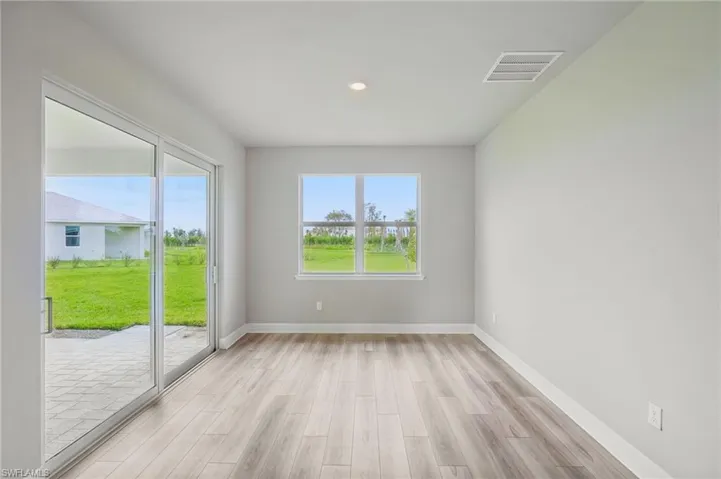 Empty room with light hardwood / wood-style floors