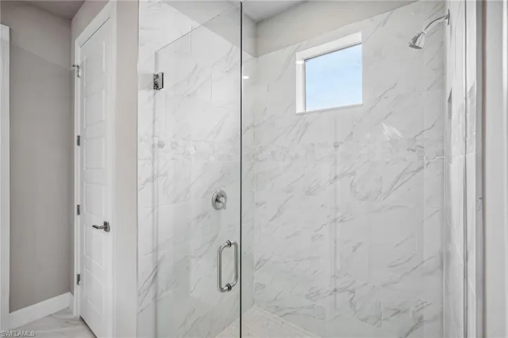 Bathroom featuring a shower with door