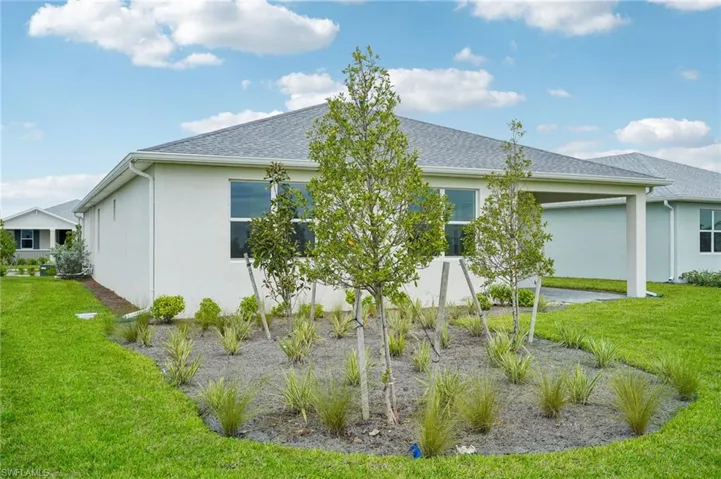 Rear view of house with a yard