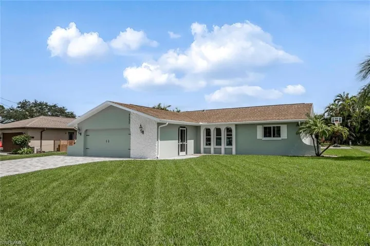 Ranch-style home featuring a garage, decorative driveway, and stucco siding
