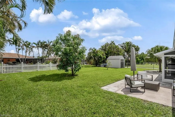 View of yard featuring a storage shed and a patio