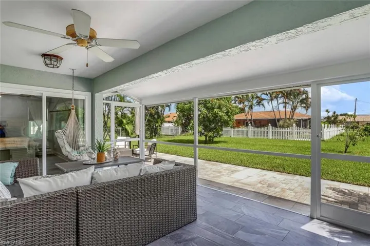 Sunroom / solarium with ceiling fan and an outdoor living space
