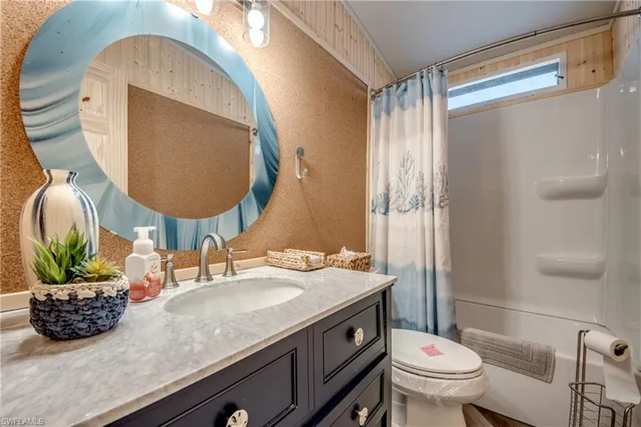 Bathroom with shower / bath combo and vanity